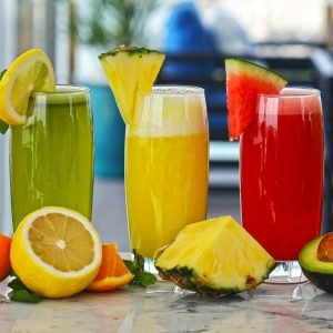 A vibrant array of fresh fruit juices with garnishes, offering a healthy and refreshing drink option.